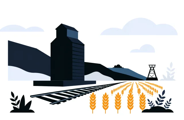 Grain elevator beside a railway track on the Saskatchewan prairie with wheat and a potash headframe.